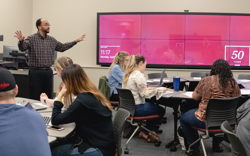 An instructor leading class in an active learning classroom