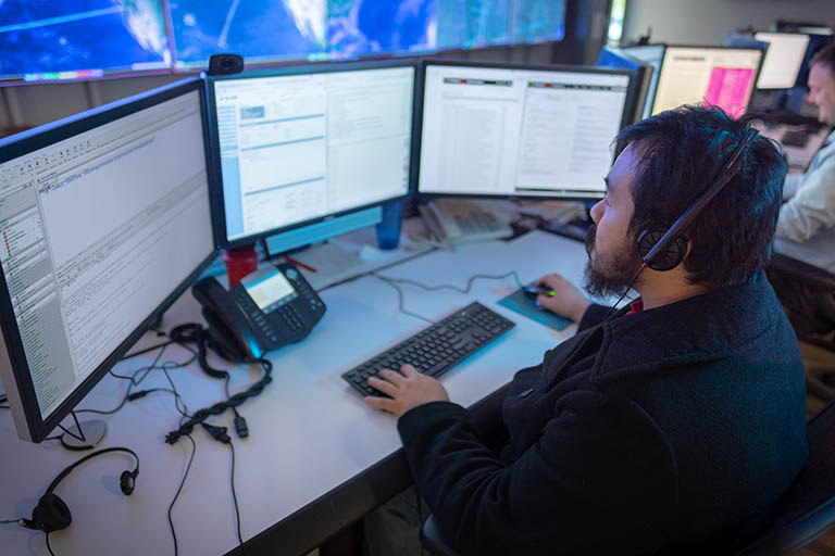 Working at a desk in the GlobalNOC at IU Bloomington.