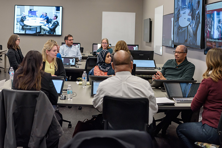 A meeting of ITCP board members in a classroom.