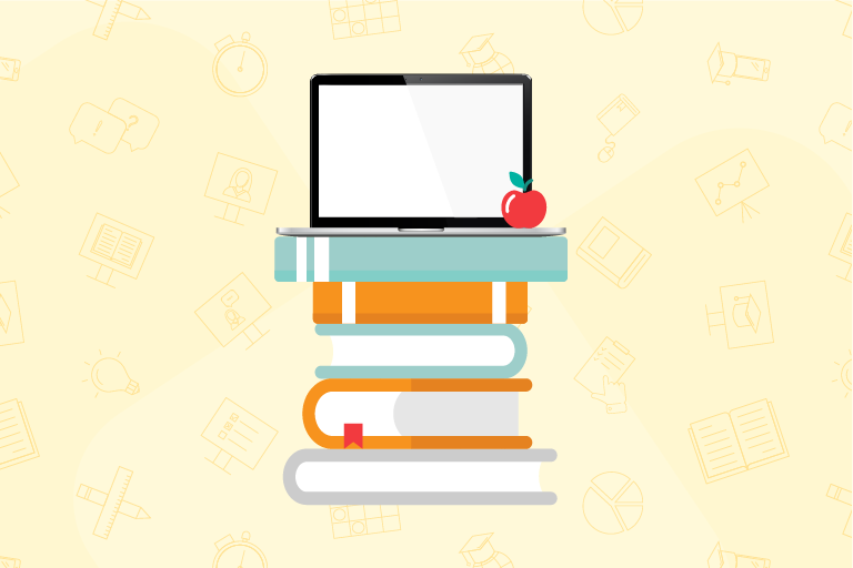 Laptop and apple on top of a stack of books